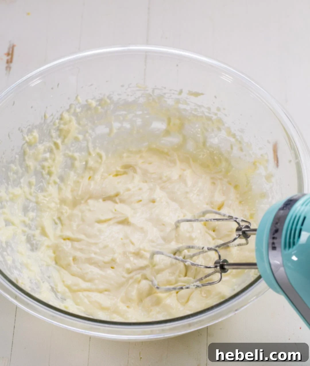 Velvet Amaretto Strawberry Trifle 3 Close-up of the smooth, creamy Amaretto cream cheese mixture in a stainless steel mixing bowl, prepared and ready for layering.