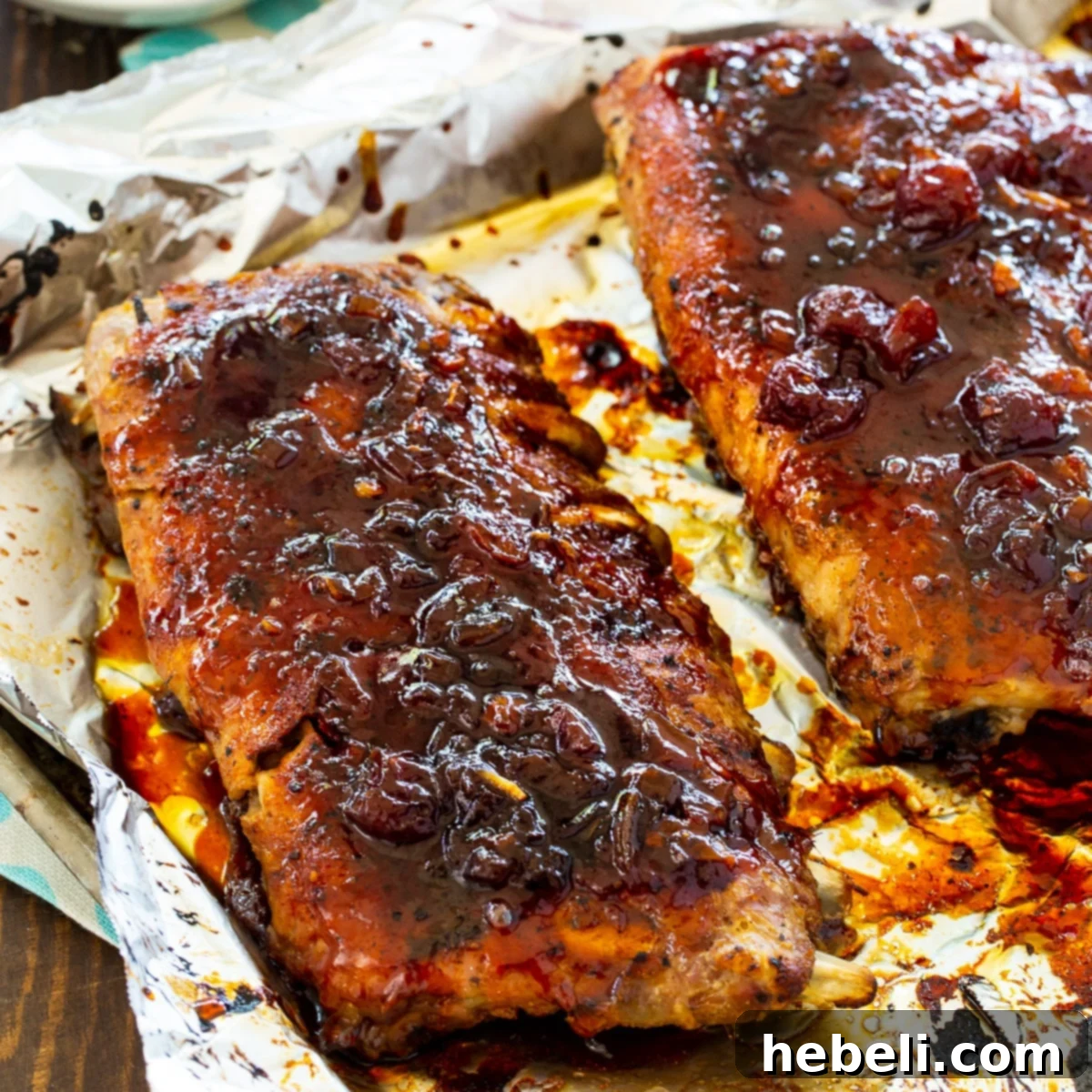 Perfectly glazed baby back ribs resting on a baking sheet, ready to be served.