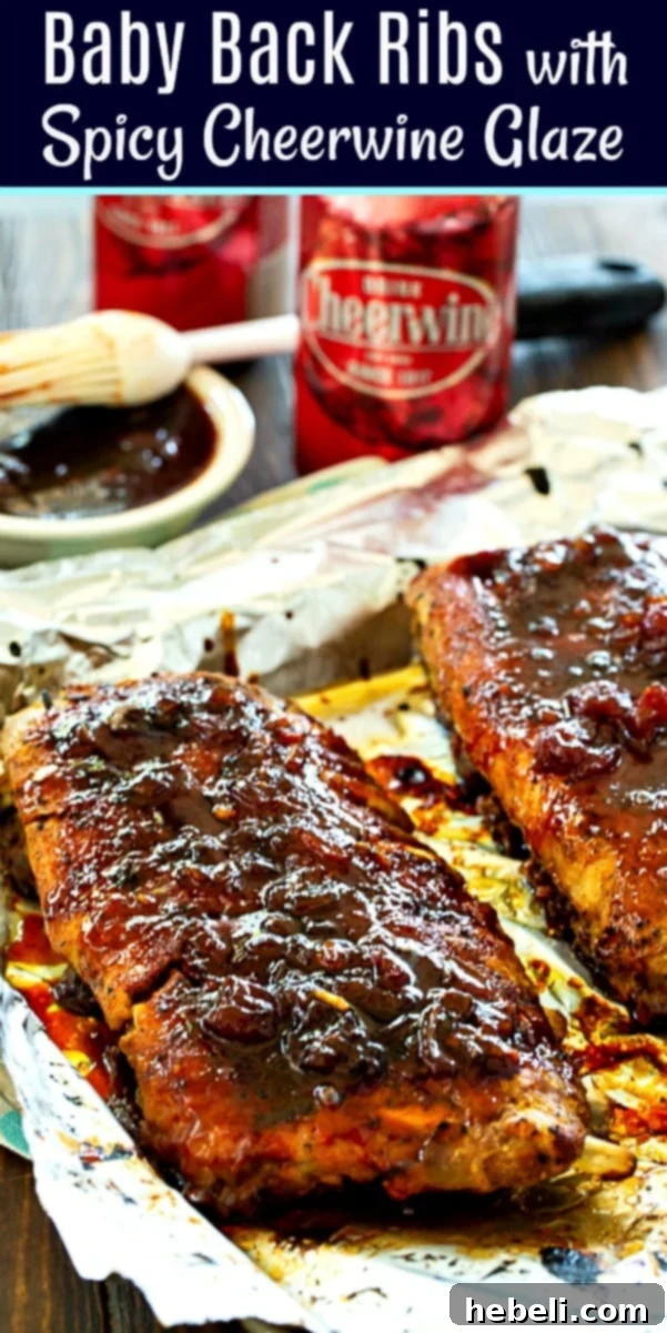 Close-up of a serving of Baby Back Ribs with Spicy Cheerwine Glaze, garnished with fresh herbs.
