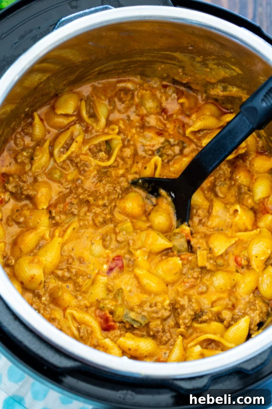 Close-up shot of creamy taco pasta simmering inside an Instant Pot, showcasing the rich texture and steam.