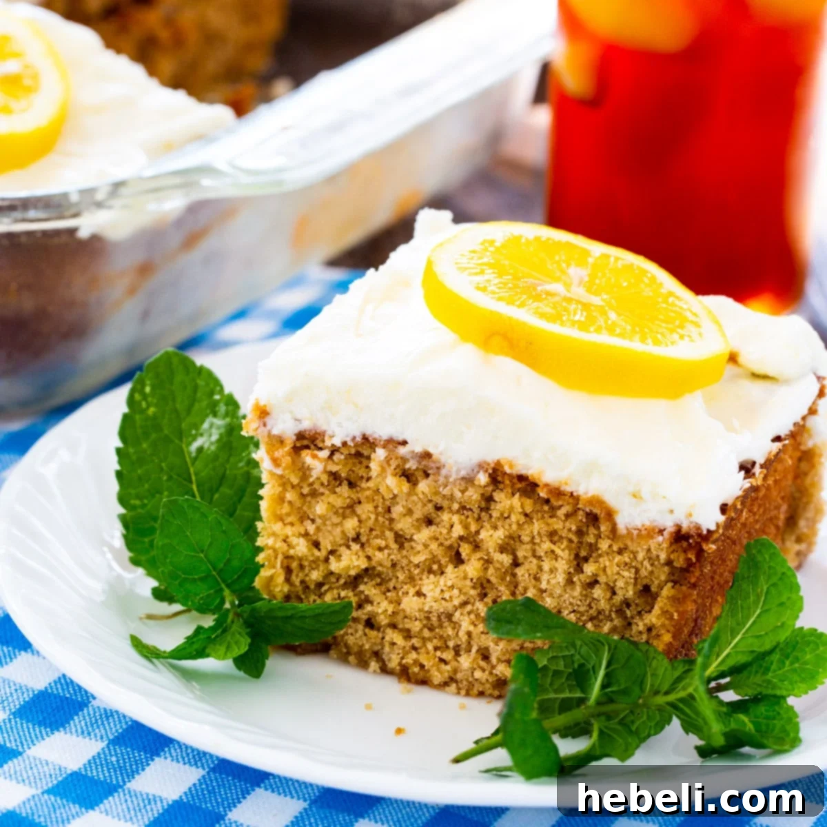Southern Sweet Tea Lemonade Cake 2 A beautiful slice of Sweet Tea and Lemonade Cake presented on a plate, garnished with fresh mint.