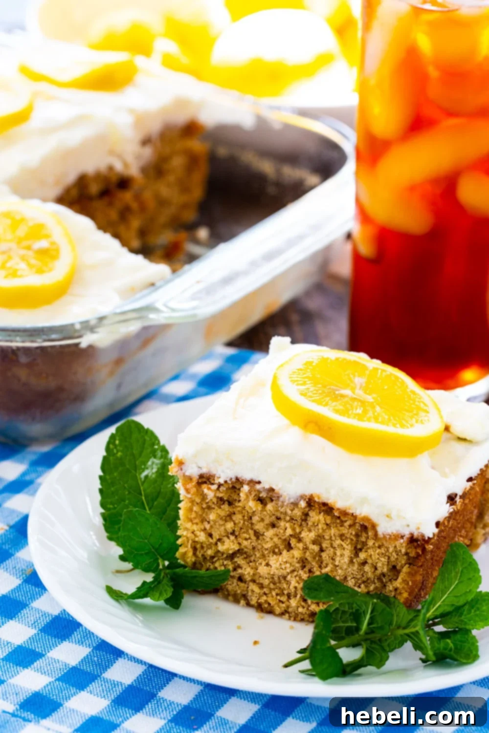 Southern Sweet Tea Lemonade Cake 4 A delicious slice of Sweet Tea and Lemonade Cake served with a refreshing glass of iced tea.