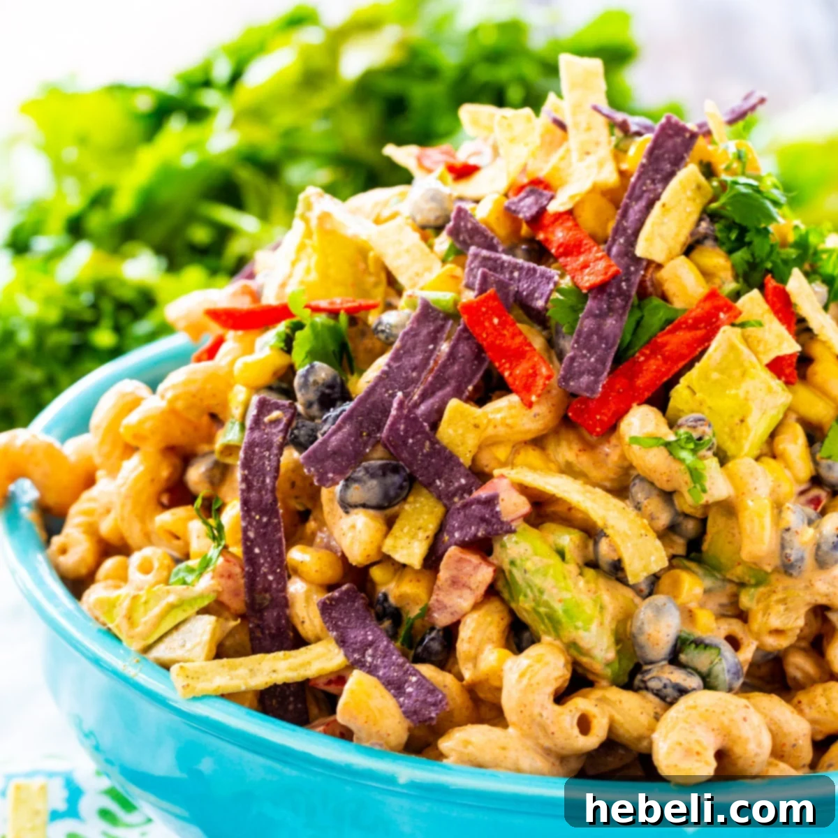 Easy Tex-Mex Pasta Salad Recipe 2 A vibrant Tex-Mex Pasta Salad served in a rustic blue bowl, showcasing the colorful blend of pasta, corn, black beans, and red bell pepper.