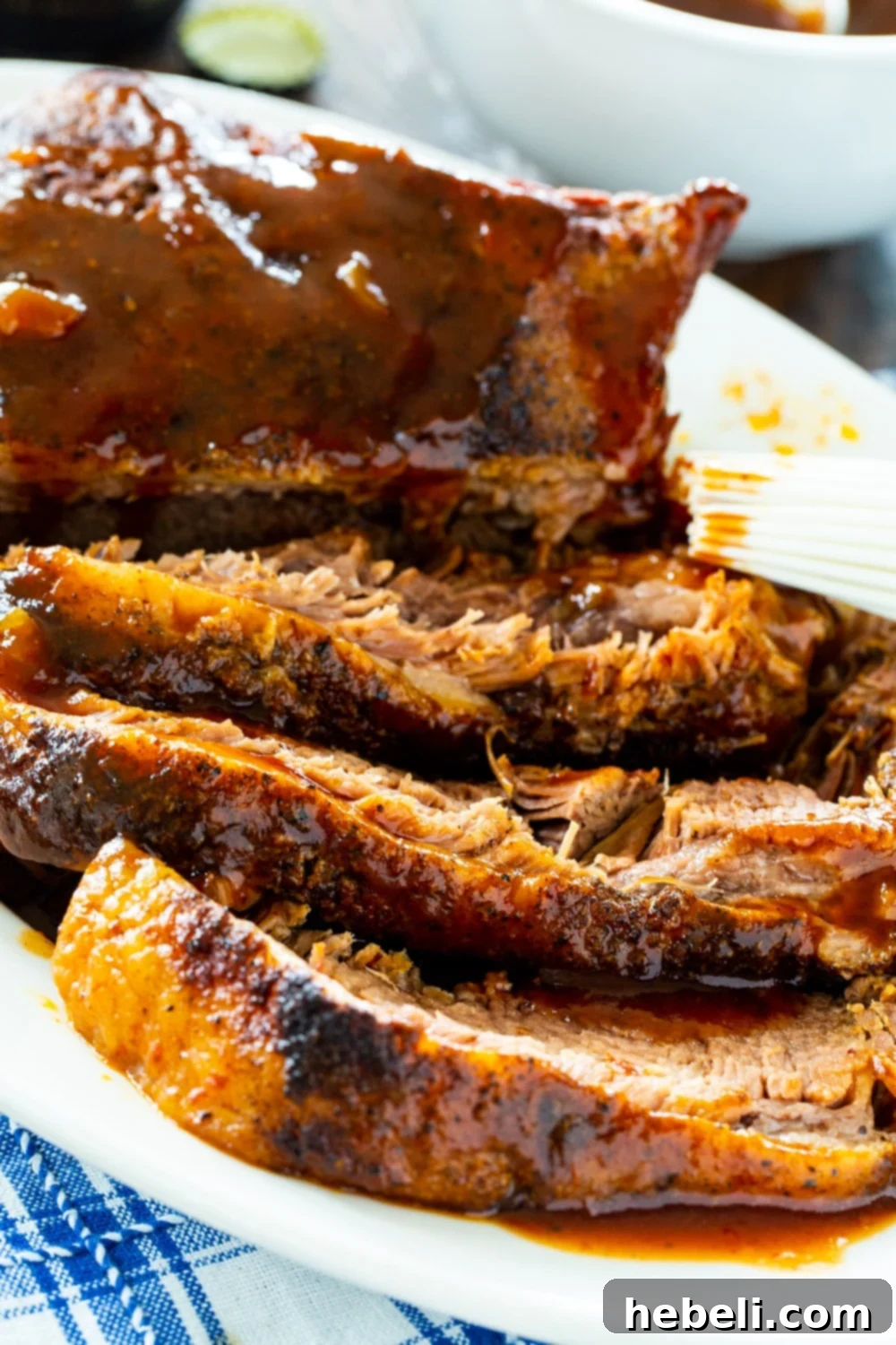 Close-up view of perfectly sliced, incredibly tender Slow Cooker Brisket, showcasing its juicy texture.