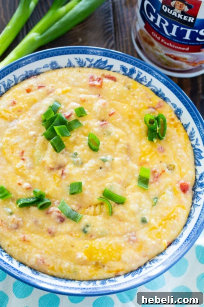 Creamy Tomato Cheese Grits 4 A close-up of a serving of Cheesy Tomato Grits, garnished with green onions.