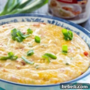 Creamy Tomato Cheese Grits 5 Finished Cheesy Tomato Grits in a rustic bowl, garnished with fresh green onions.