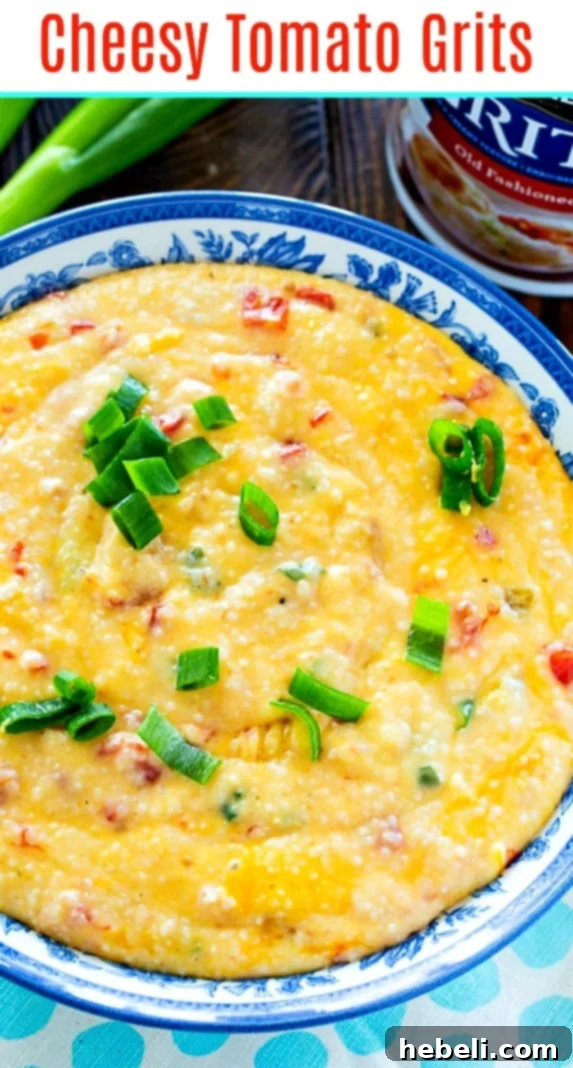 Creamy Tomato Cheese Grits 6 A wide shot of a serving of Cheesy Tomato Grits garnished with fresh green onions and a spoon, ready to eat.