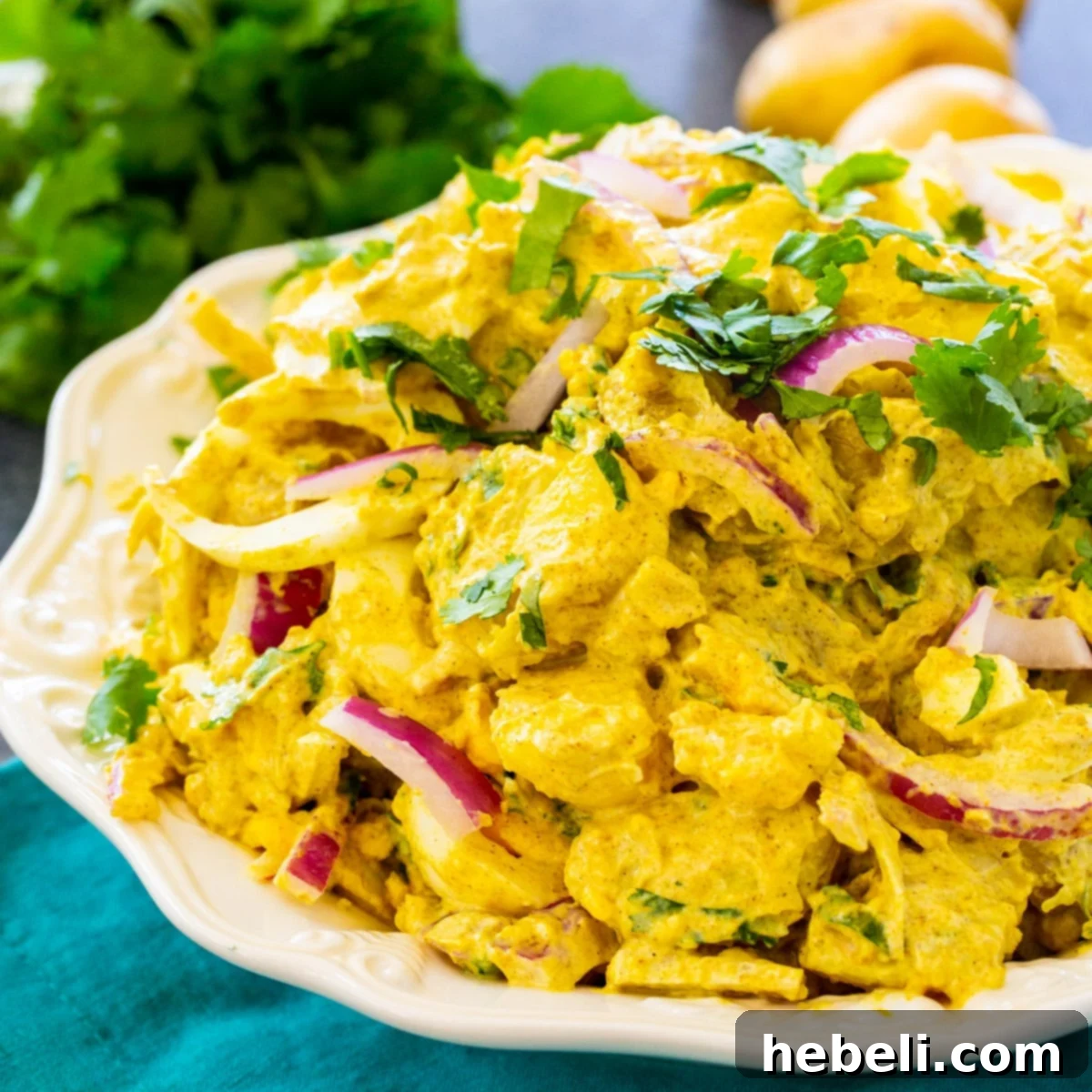 Curried Potato Salad topped with fresh cilantro in a rustic serving bowl, ready to be enjoyed.
