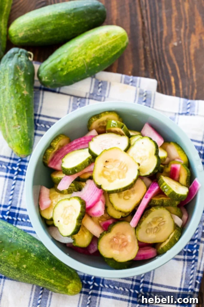 Close-up of freshly sliced pickled cucumbers and onions, showcasing their crisp texture and vibrant colors.