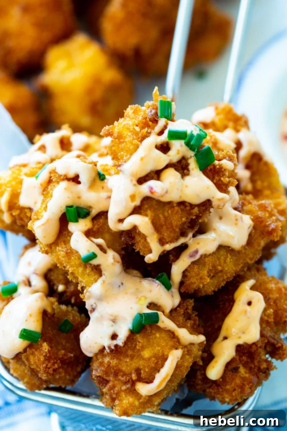 Close-up view of golden-brown, fried Bang Bang Chicken pieces, showcasing their crispy texture.