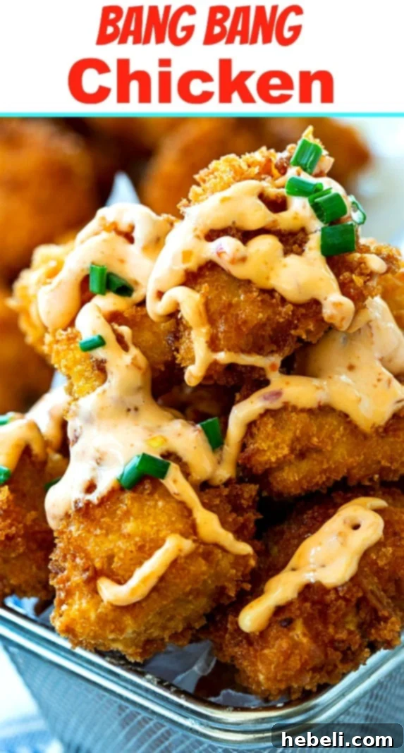 A close-up of Bang Bang Chicken drizzled with sauce, showcasing its appealing texture.