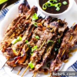 Marinated Steak Skewers with Korean BBQ Sauce on a white serving plate.