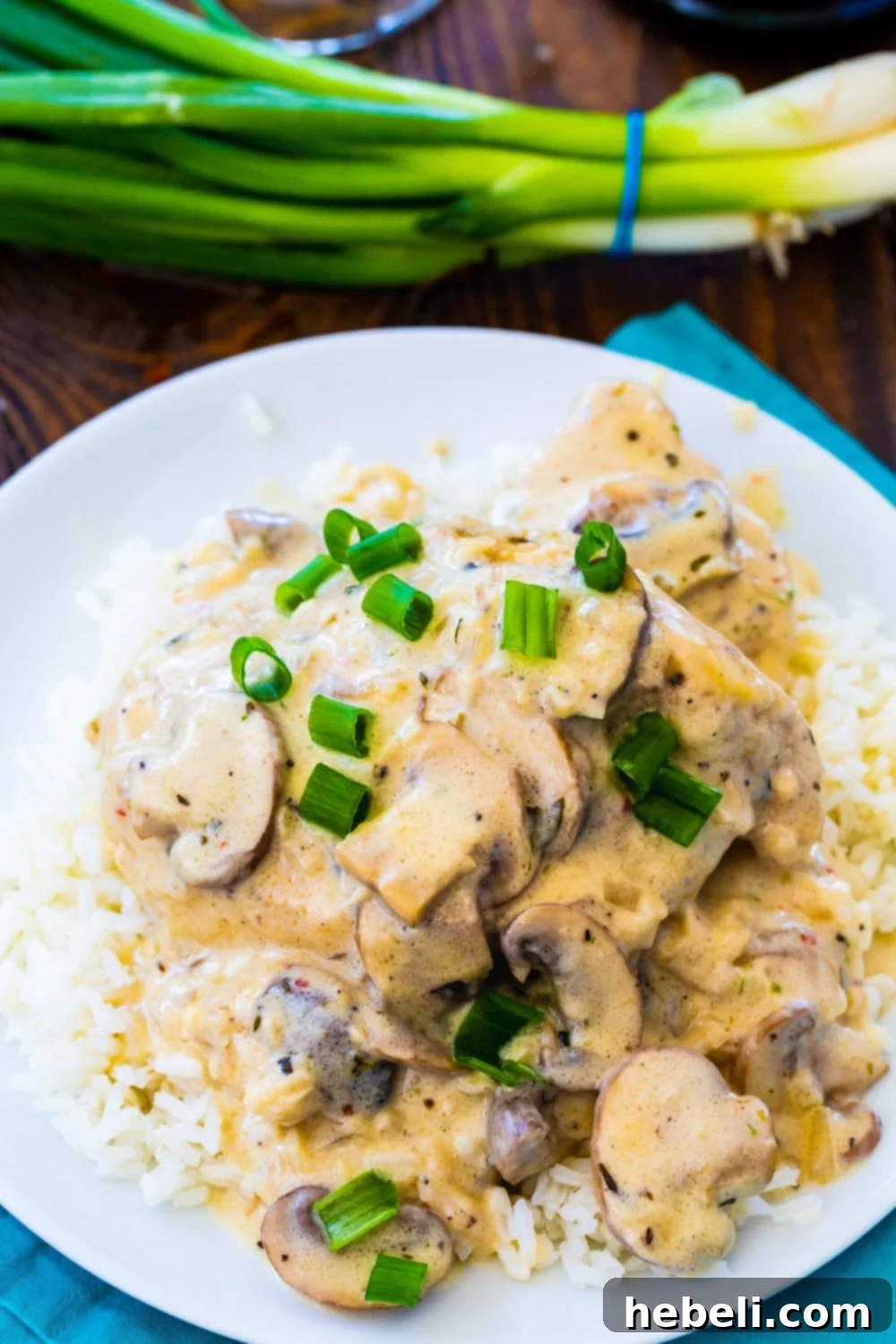 Instant Pot Champagne Chicken served over rice on a white plate, ready to be enjoyed.