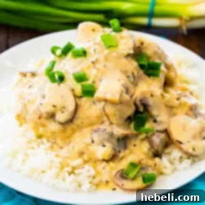 Instant Pot Champagne Chicken over rice on a white plate.
