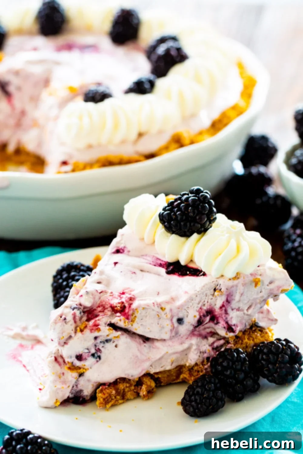 No-Bake Blackberry Cheesecake Delight 3 Slice of Blackberry Pie with rest of the pie in background.