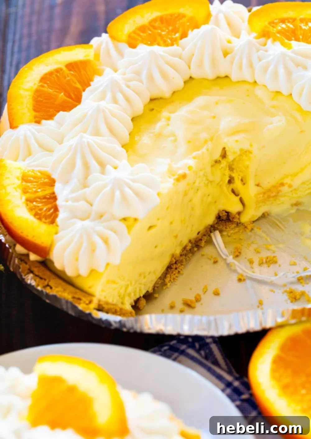 The full Orange Creamsicle Pie, unsliced, resting in its graham cracker crust within a pie pan, ready for chilling or serving, showcasing its smooth, inviting surface.