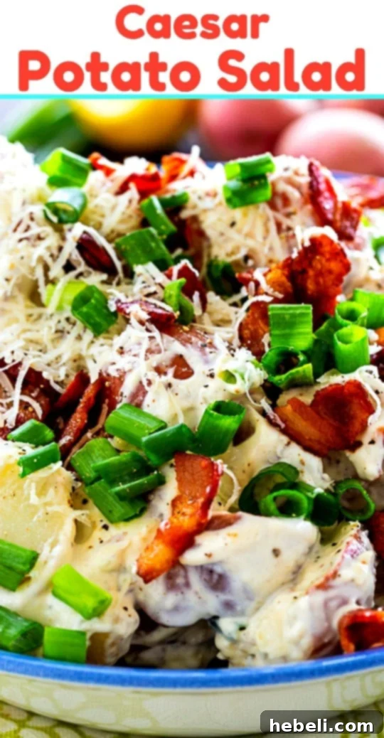 Caesar Potato Salad served in a large rustic bowl, garnished with fresh herbs and a wooden spoon