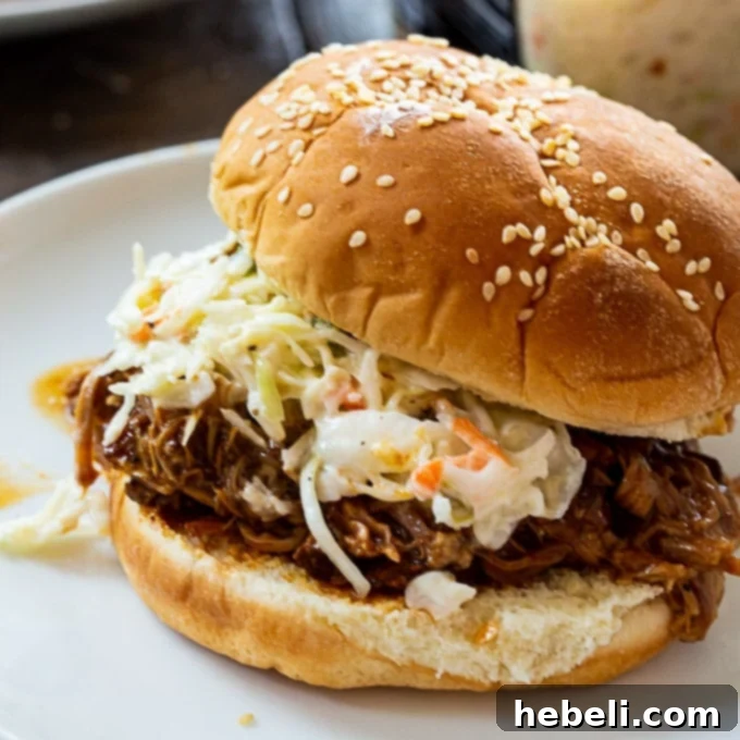 Delicious Instant Pot Pulled Pork served on a toasted bun with a side of creamy coleslaw.