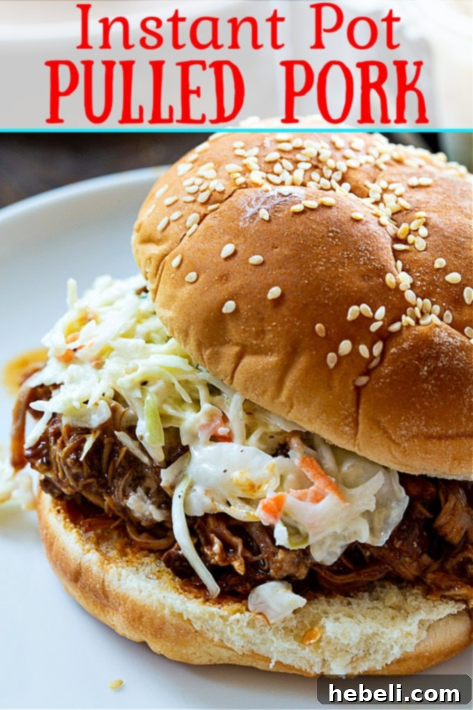 A close-up shot of juicy, shredded Instant Pot Pulled Pork, ready to be served.