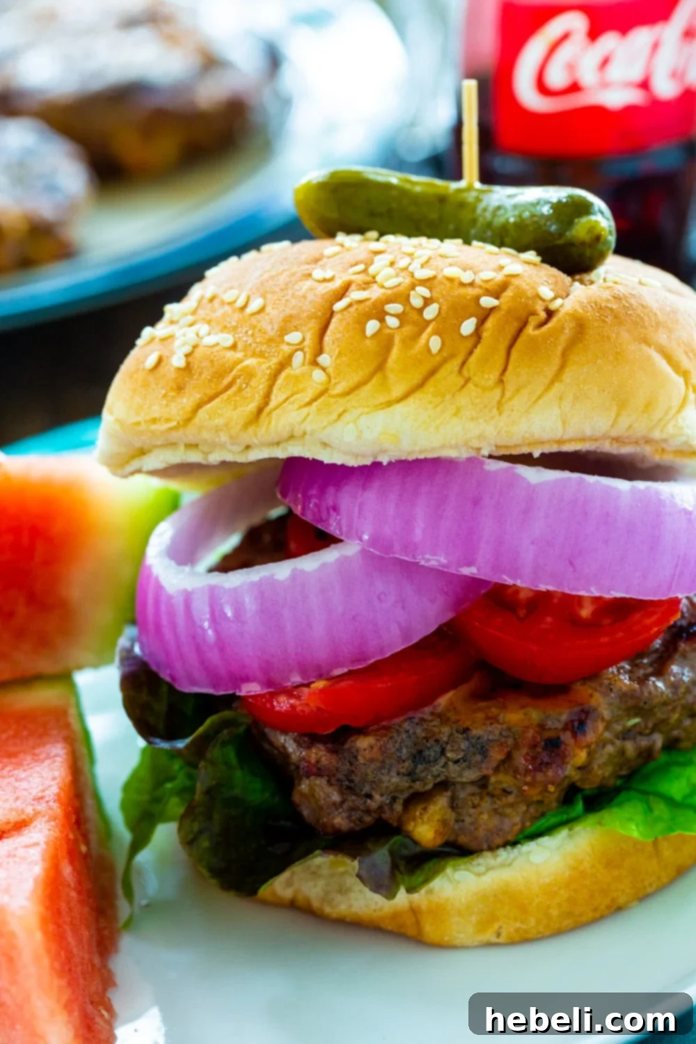 Close-up shot of a perfectly grilled Cola Burger, showcasing its juicy interior and caramelized glaze, ideal for summer celebrations.