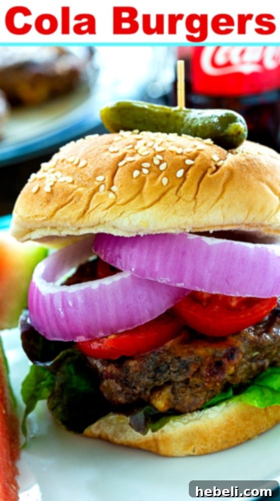 A beautifully presented Cola Burger with crisp lettuce, ripe tomato, and thinly sliced red onion on a fresh bun, highlighting its appeal.