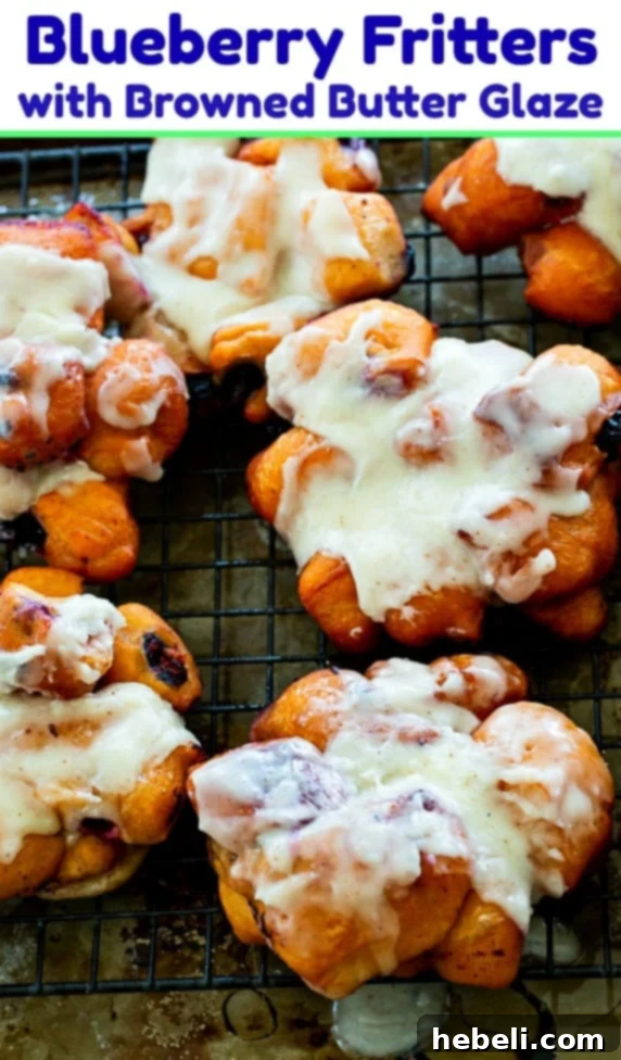 A stunning stack of fresh Blueberry Fritters, beautifully glazed and ready for serving.