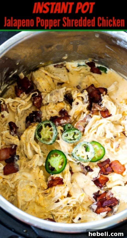 Close-up of creamy Jalapeno Popper Shredded Chicken still in the Instant Pot, showing its rich texture and delicious ingredients.