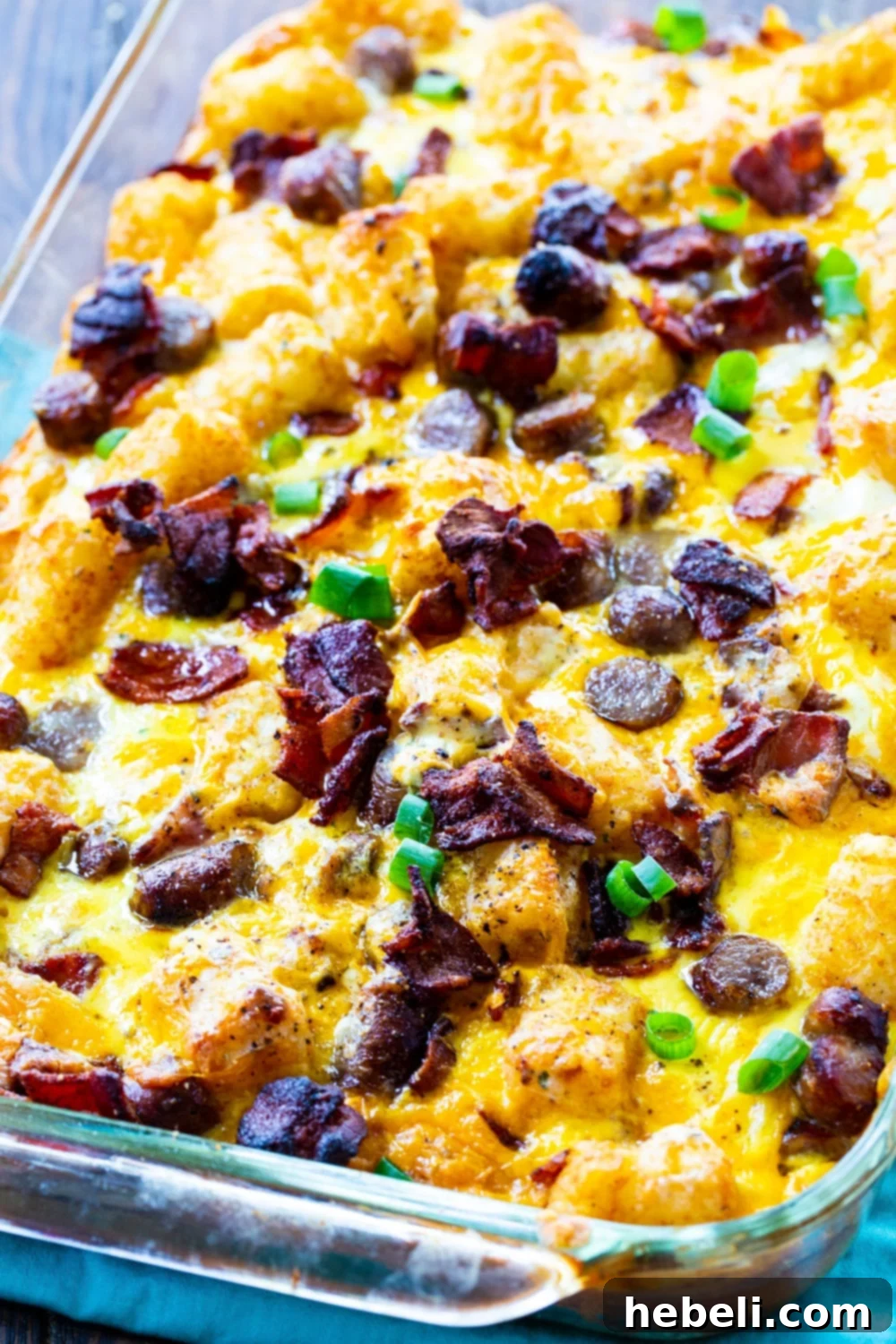 Hearty Tater Tot Breakfast Bake 3 Unbaked Tater Tot Breakfast Casserole in a baking dish, ready for the oven.