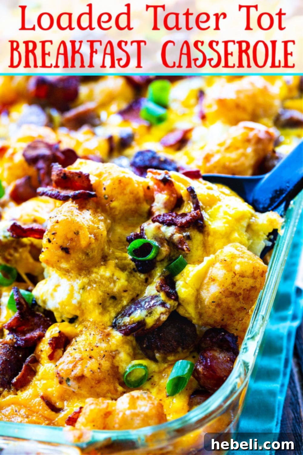 Hearty Tater Tot Breakfast Bake 4 Close-up of a slice of Loaded Tater Tot Breakfast Casserole showing crispy tater tots, bacon, sausage, and melted cheese.