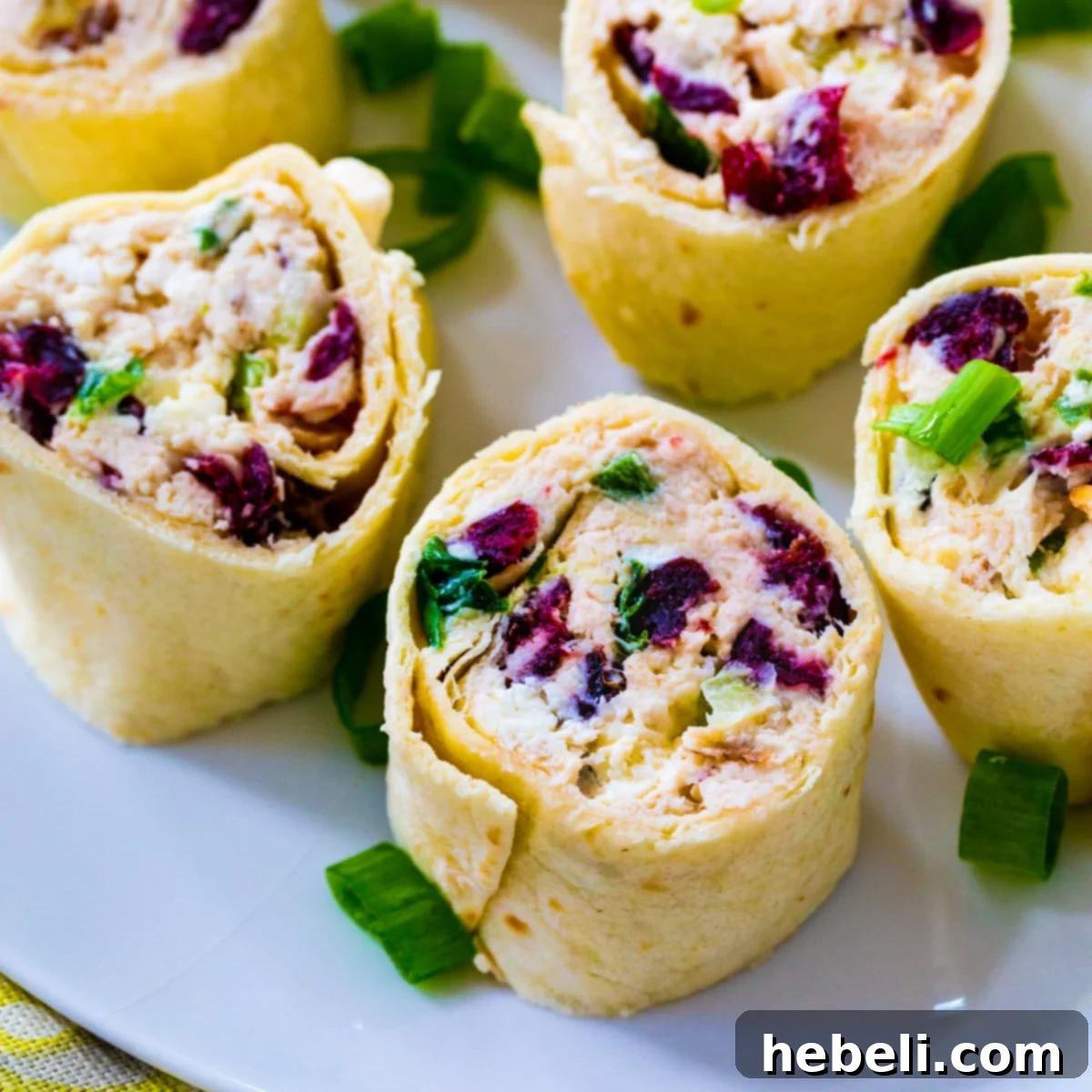 Delicious Chicken Cranberry Pinwheels arranged on a serving platter, ready to be enjoyed as an appetizer.