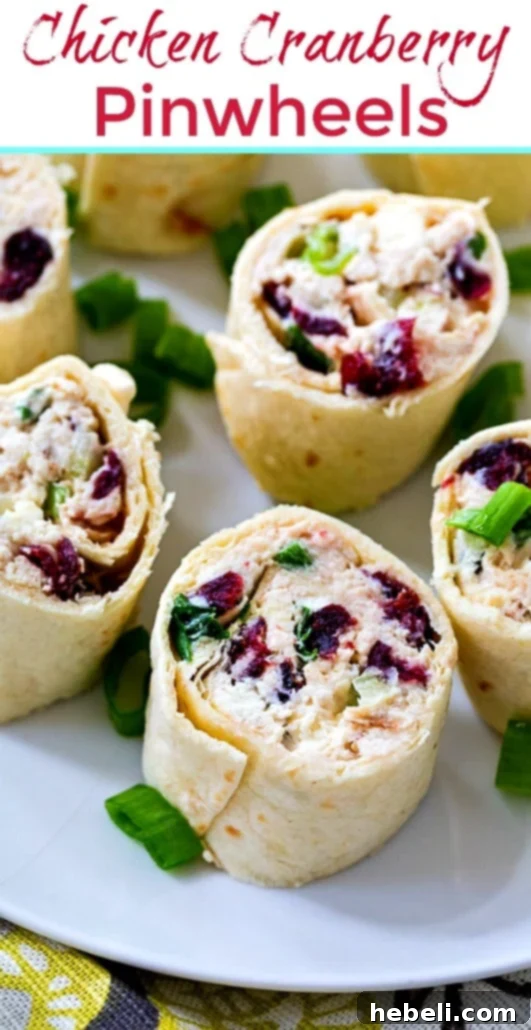 Stacked Chicken Cranberry Pinwheels, showcasing their beautiful spiral and delicious, colorful filling.