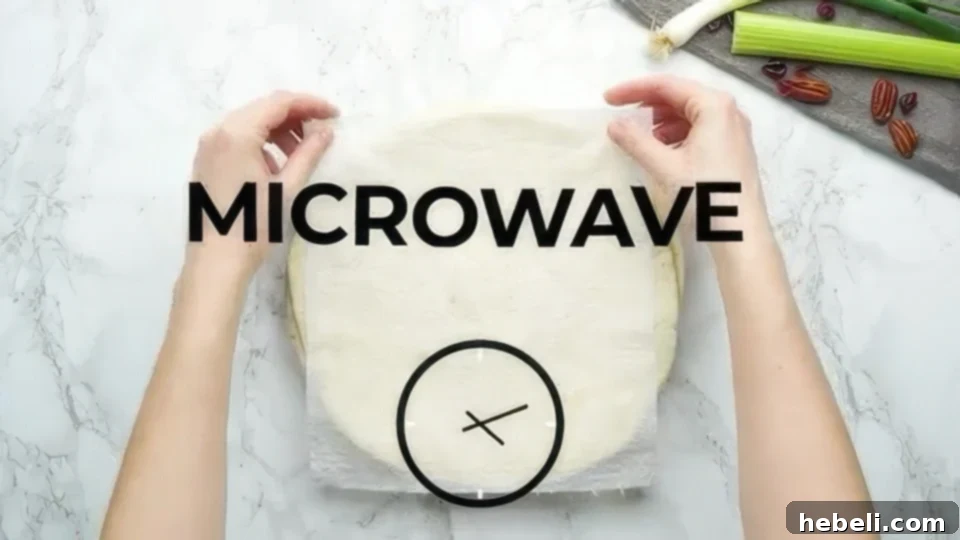 Microwaving flour tortillas covered with a damp paper towel to soften them, preparing them for easy and flexible rolling.