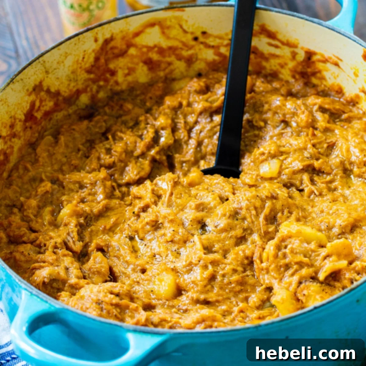 A Dutch oven filled with rich, savory South Carolina Barbecue Hash, ready to be served.