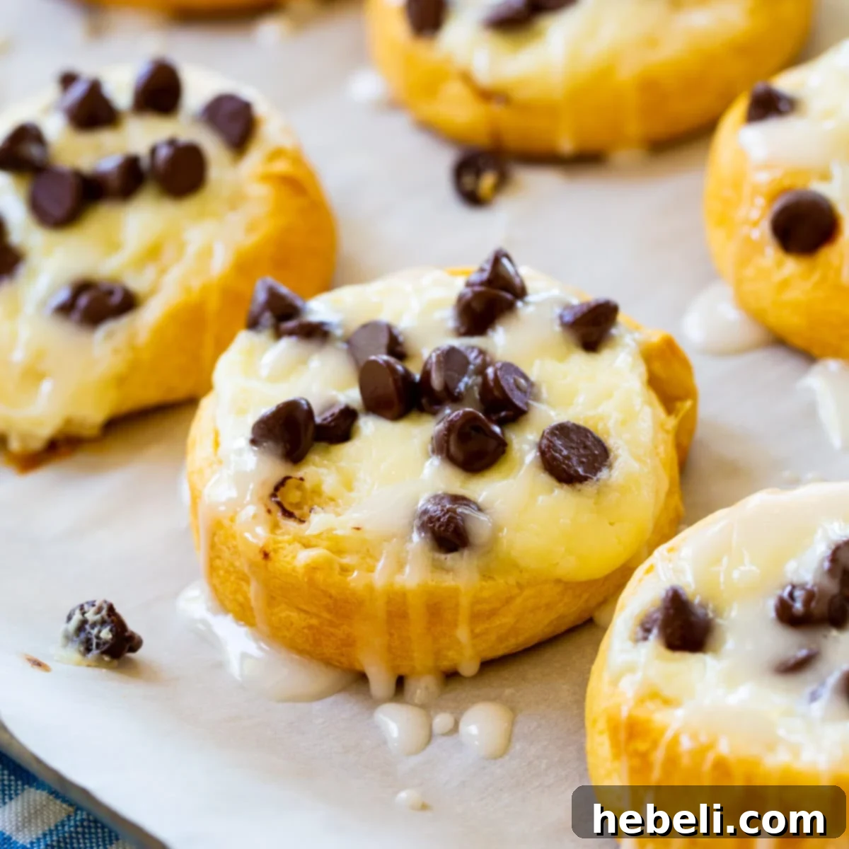 Golden brown Chocolate Chip Cream Cheese Danishes arranged beautifully on a baking sheet, ready to be enjoyed.