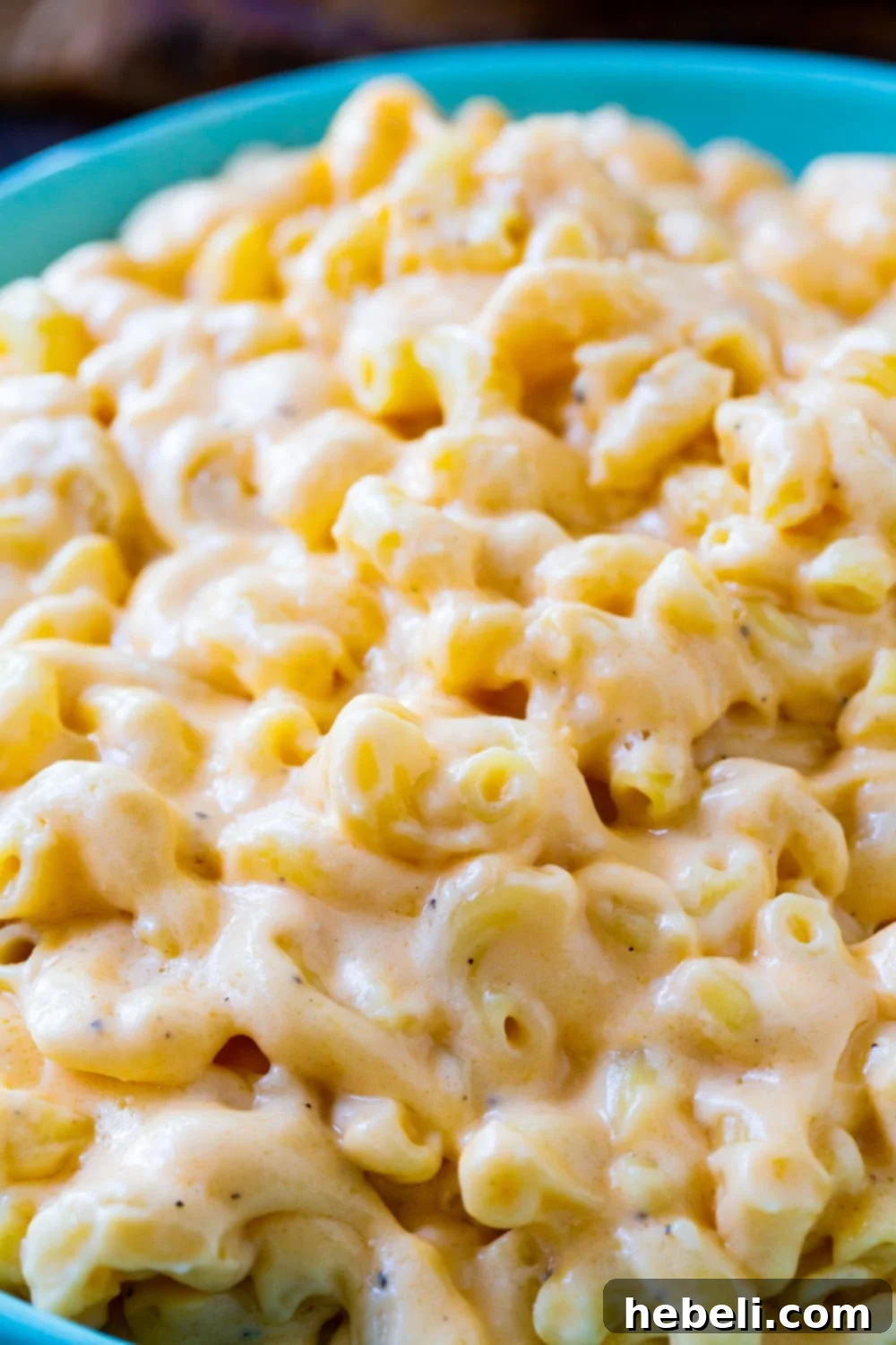 Velvet Mac and Cheese 4 Close-up of a serving of Velvet Mac and Cheese in a blue bowl, showing its rich and creamy texture.