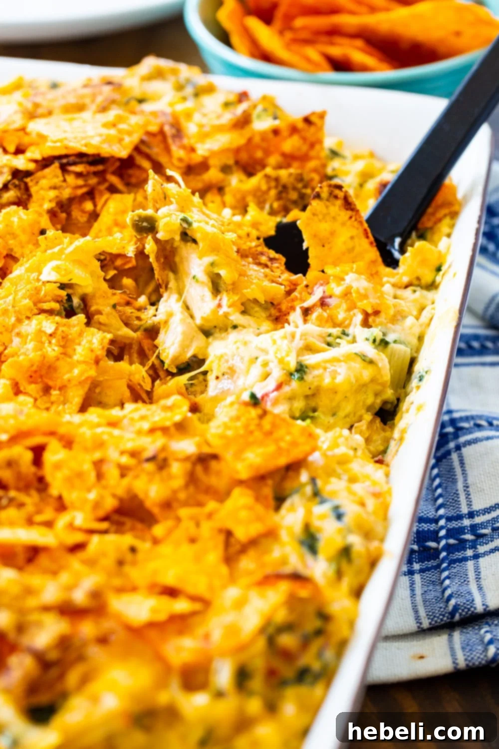 Spoon scooping a portion of Southwestern Turkey Casserole from the dish.