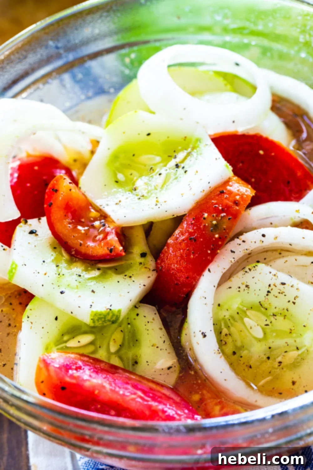Close-up view of the vibrant Marinated Cucumber, Tomato, and Onion Salad, highlighting the texture and freshness of the vegetables.