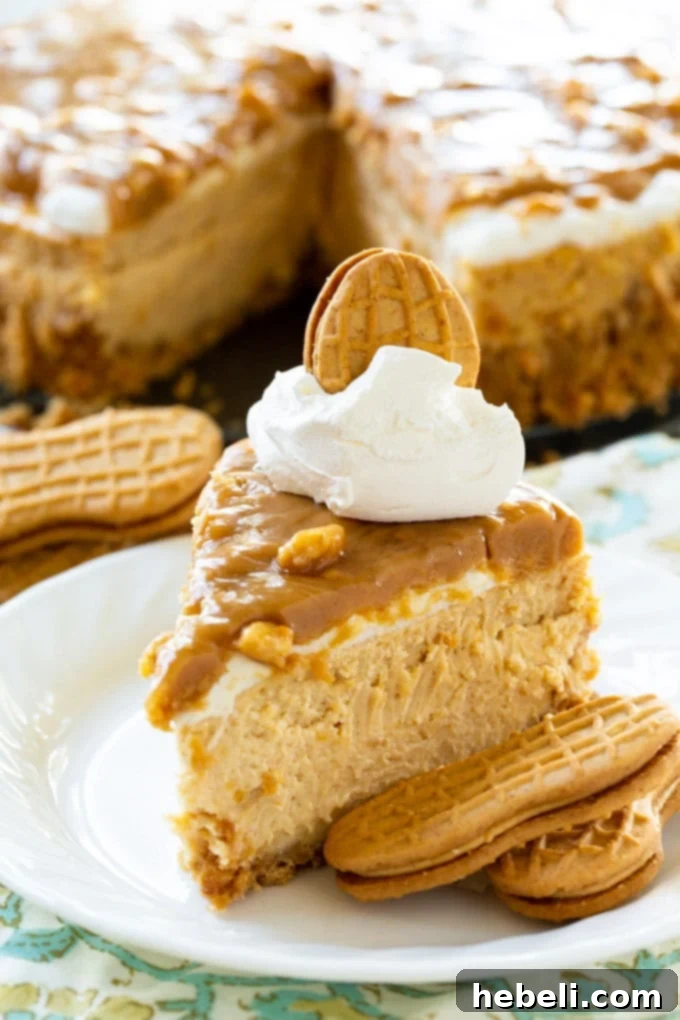 Decadent Peanut Butter Cheesecake 5 Whole Peanut Butter Cheesecake with a Nutter Butter crust and glossy peanut butter glaze, presented on a wooden board.