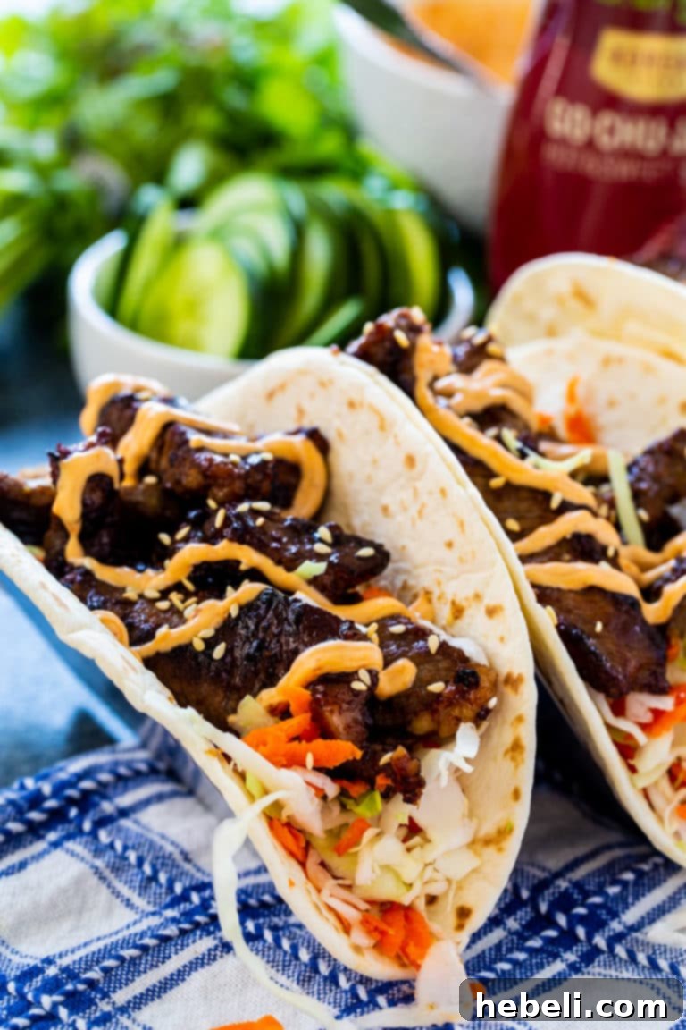 Korean BBQ Tacos 3 Close-up of a Korean Bulgogi Taco, highlighting the tender beef and vibrant toppings.