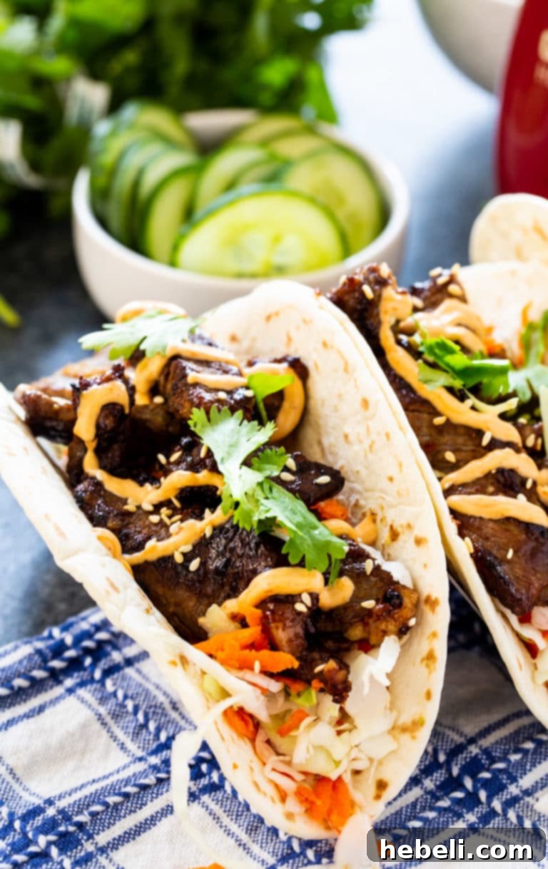 Korean BBQ Tacos 4 A close-up shot of Korean Bulgogi Tacos, garnished with fresh cilantro and sesame seeds.