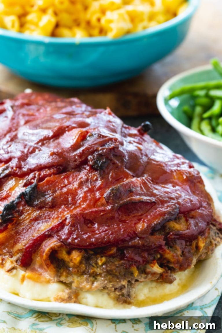 Bacon Enrobed Meatloaf 4 Close-up of Bacon Wrapped Meatloaf with a glistening brown sugar ketchup glaze before slicing.