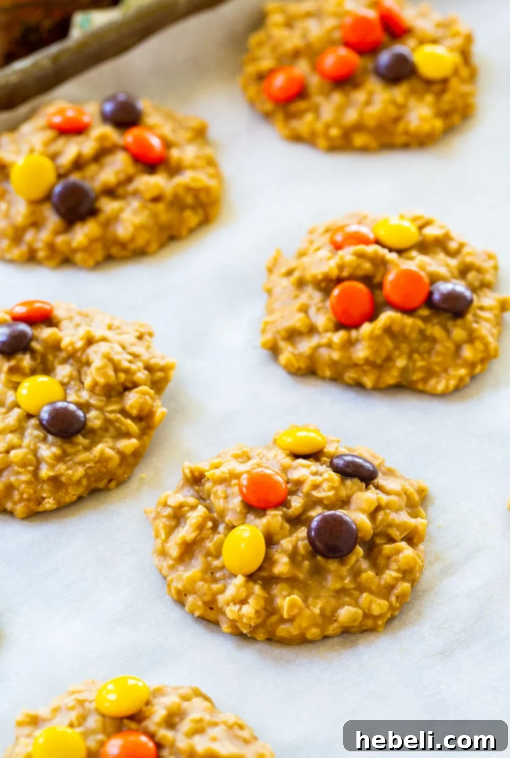 Peanut Butter Oat Energy Bites 3 Freshly made No-Bake Oatmeal Cookies arranged on a baking sheet, showcasing their delightful texture and readiness.