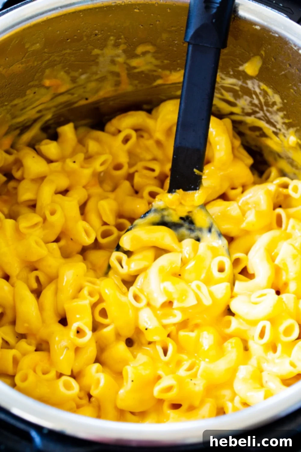 Macaroni and cheese ingredients cooking inside an Instant Pot.