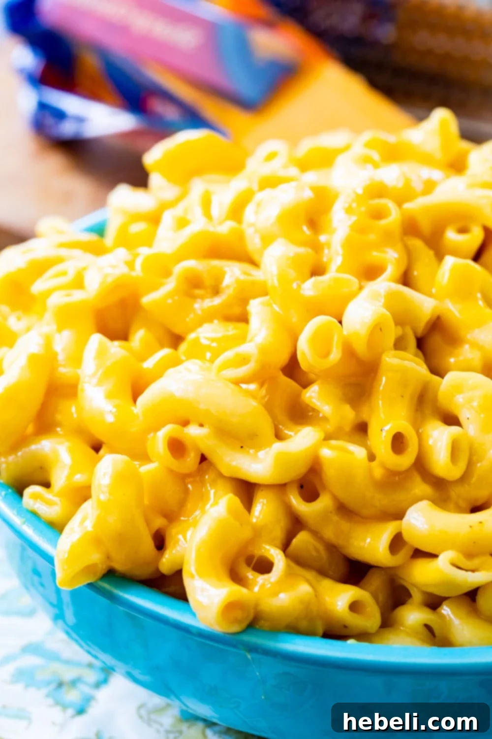 A serving of Instant Pot Mac and Cheese in a stylish blue bowl, ready to enjoy.