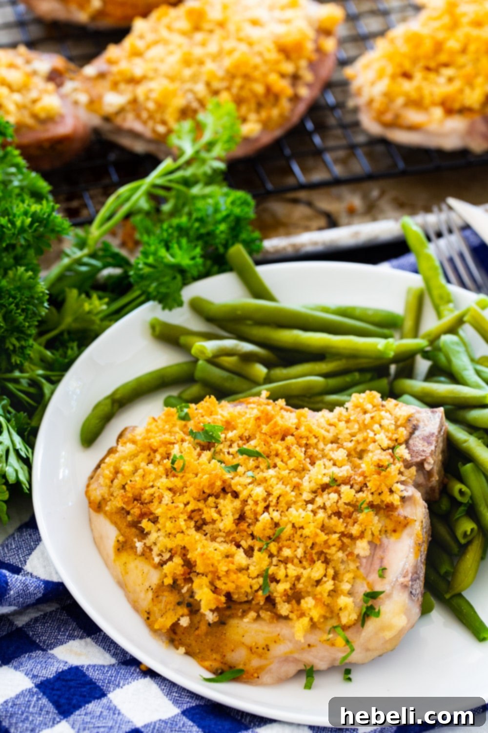Spicy Pan-Seared Pork Chops 3 Close-up of a single Deviled Pork Chop served with green beans, showcasing the crispy Panko and rich mustard coating.