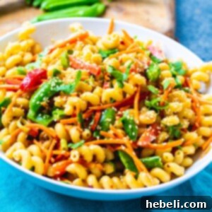 Asian Fusion Pasta Salad 5 Asian Pasta Salad in a bowl, ready to be served. A delicious and colorful representation of the finished dish.