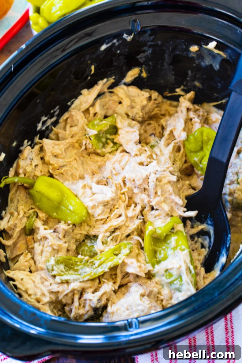 Close-up of Creamy Mississippi Chicken simmering in a slow cooker, showing tender chicken and creamy sauce.