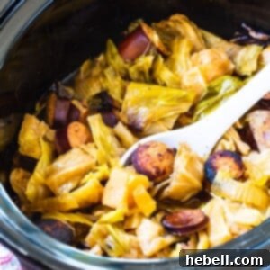 Hearty Slow Cooker Cabbage and Kielbasa 5 Crock Pot Cabbage and Kielbasa in black slow cooker.