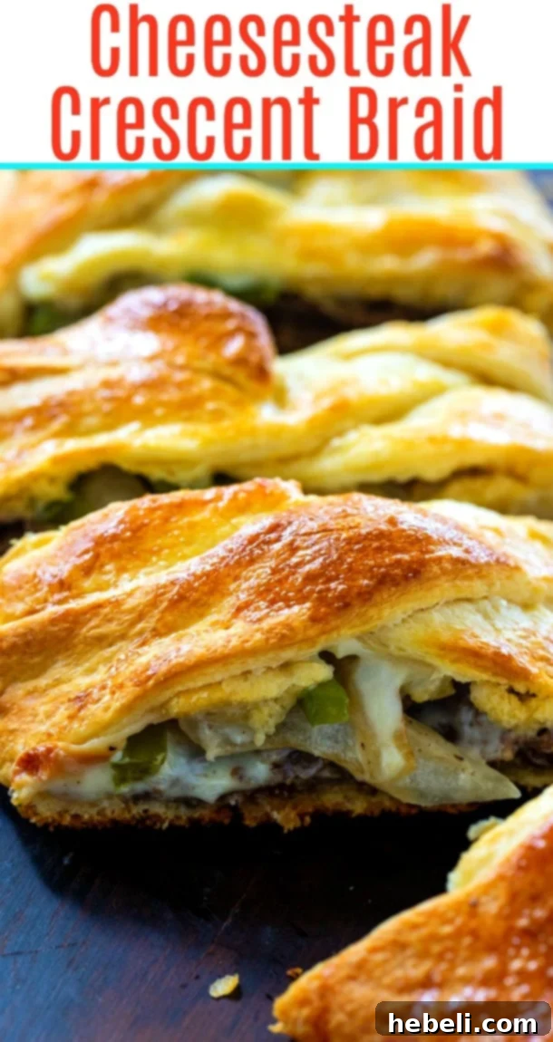 A beautifully golden-brown Cheesesteak Crescent Braid, ready to be sliced and served, perfect as an easy appetizer or game day snack.