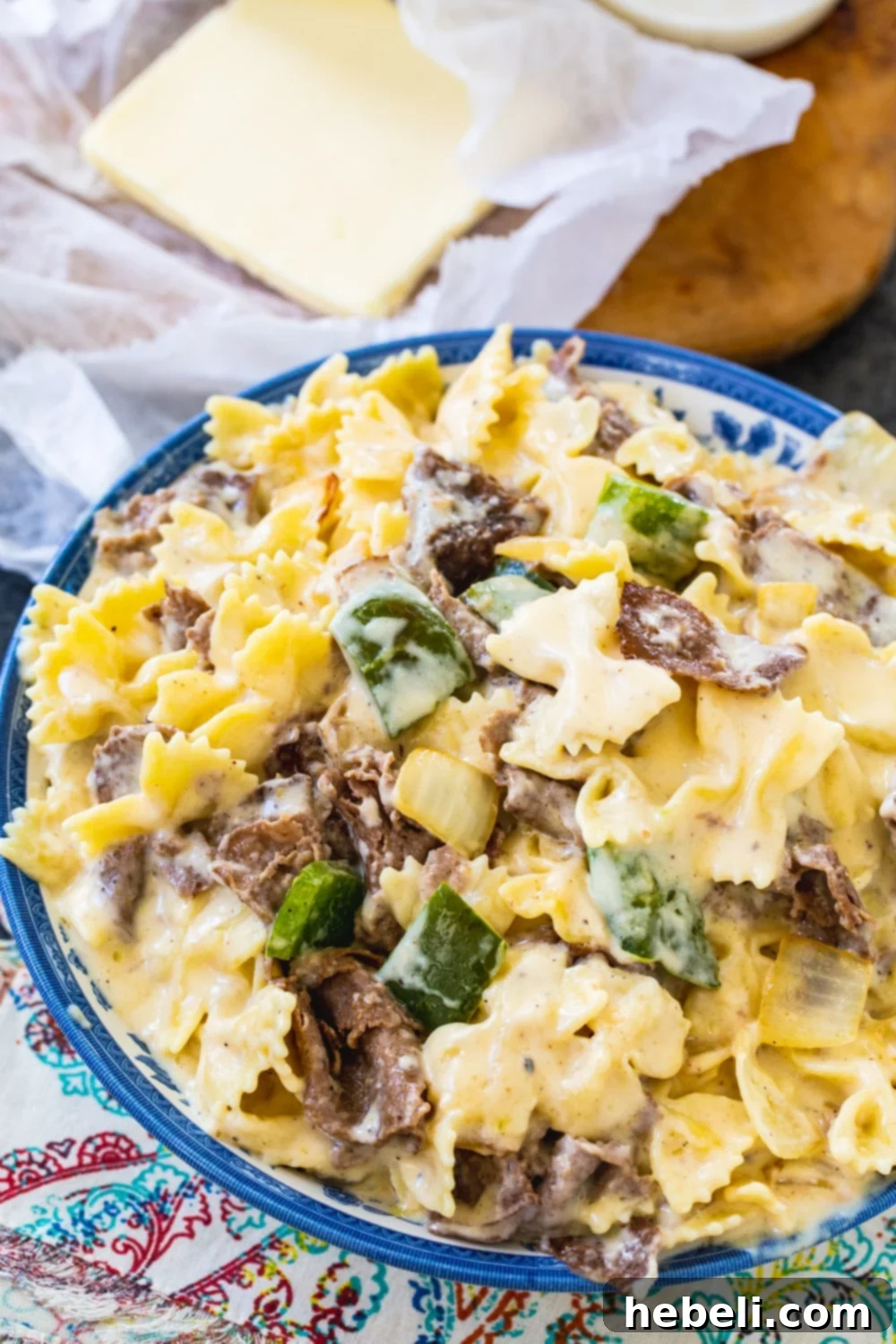 Ultimate Philly Cheesesteak Mac 3 Close-up shot of creamy Mac and Cheese in a serving bowl, showcasing the rich cheese sauce and perfectly cooked pasta.